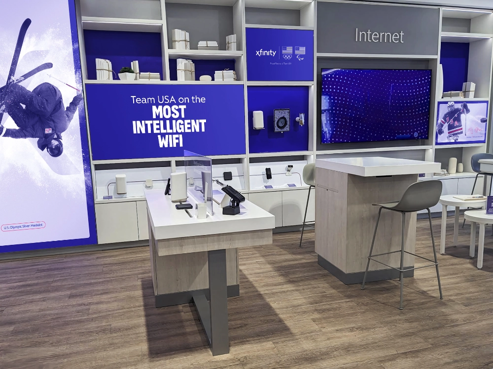 Xfinity retail internet experience zone featuring digital display and Team USA Olympic branding